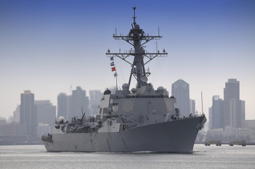Arleigh Burke-class guided missile destroyer leaving port.